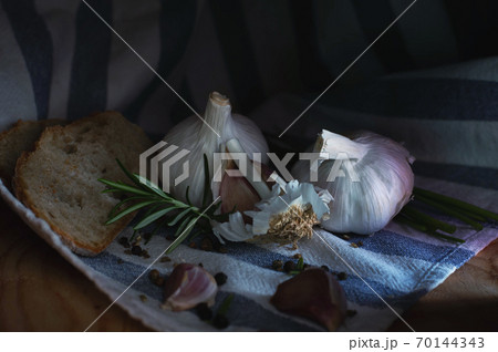 garlic black bread rosemary on a towel 70144343