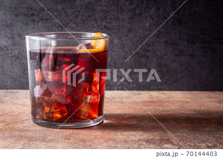 Boulevardier cocktail and orange zest on rusty background.Copy space Boulevardier cocktail and orange zest on rusty background.Copy space 70144403