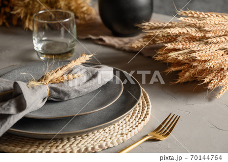 Autumn table setting with dry yellow oak leaves 70144764