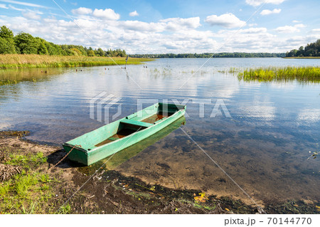 Old wooden fishing boat on the lake Old wooden fishing boat on the lake 70144770