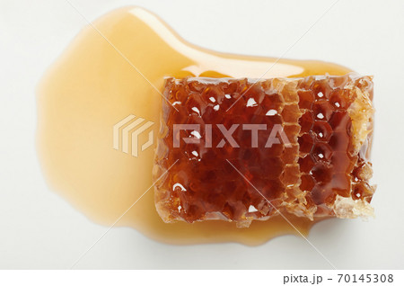 Slice of gold color honey in comb Slice of gold color honey in comb 70145308