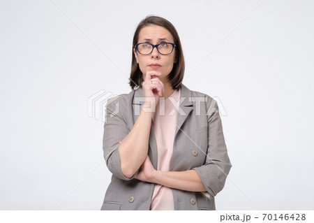 Mature caucasian lady in glasses thinking, making a decision 70146428