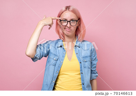 Woman generates new idea in mind, looks thoughtfully 70146613