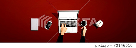 Person using a laptop computer with a piggy bank Person using a laptop computer with a piggy bank 70146616