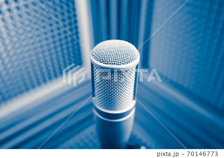 professional microphone in sound recording studio, blue acoustic foam background professional microphone in sound recording studio, blue acoustic foam background 70146773