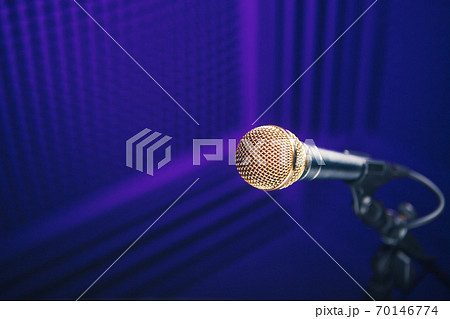 golden microphone on stand, purple background with acoustic foam in studio 70146774