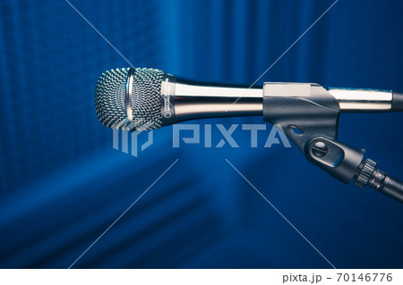 microphone on stand, blue background with acoustic foam wall in studio microphone on stand, blue background with acoustic foam wall in studio 70146776