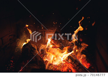 burning fire logs with sparks in the fireplace burning fire logs with sparks in the fireplace 70146777