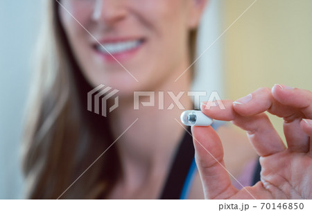 Patient in hospital holding video pill for capsule endoscopy Patient in hospital holding video pill for capsule endoscopy 70146850