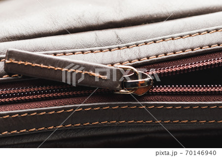 zipper of brown leather bag, close-up view 70146940