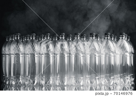 empty plastic bottles on black background with smoke, pollution concept empty plastic bottles on black background with smoke, pollution concept 70146976
