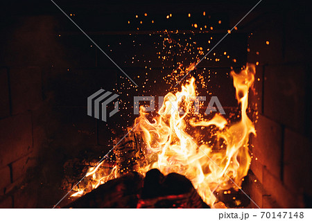 burning fire logs with sparks in the fireplace burning fire logs with sparks in the fireplace 70147148