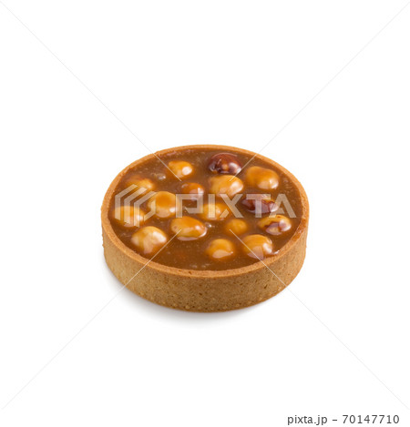 Mini tart with caramel and hazelnut isolated on a white Mini tart with caramel and hazelnut isolated on a white 70147710