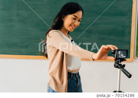 Asian school teacher preparing to deliver online course 70154286