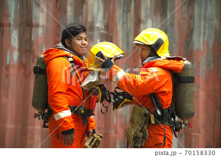 Save Download Preview The portrait of two Asian firefighters are wearing orange fire protection uniform mask and helmet front of building. Save Download Preview The portrait of two Asian firefighters are wearing orange fire protection uniform mask and helmet front of building. 70158330