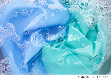 Color clothes soak in powder detergent water dissolution. Laundry concept Color clothes soak in powder detergent water dissolution. Laundry concept 70158632