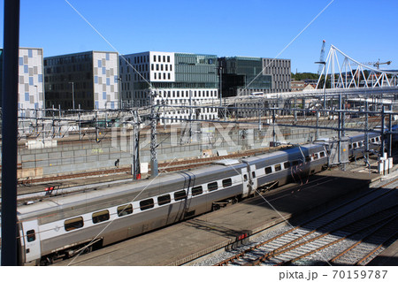 Oslo view with train station and modern buildings. They are some of the new buildings in the neighbourhood of Bjorvika, the station is the biggest of Norway. Oslo view with train station and modern buildings. They are some of the new buildings in the neighbourhood of Bjorvika, the station is the biggest of Norway. 70159787