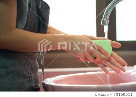 Asian woman washing hands with soap 70160011