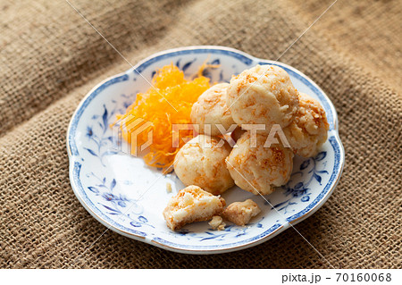 Golden cookies balls with eggs silk for tea time in morning in white plate 70160068