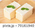Sliced of cheesecake with  mint leaves decorated on top 70161940