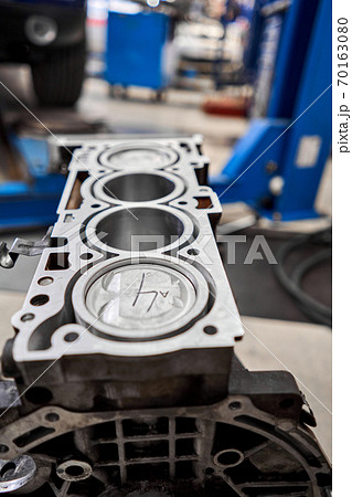 New pistons and cylinder head of engine block vehicle. Motor capital repair. Sixteen valve and four cylinder. Car service concept. The job of a mechanic. Old and new pistons. New pistons and cylinder head of engine block vehicle. Motor capital repair. Sixteen valve and four cylinder. Car service concept. The job of a mechanic. Old and new pistons. 70163080