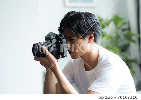 カメラを持つかっこいい男性の写真素材
