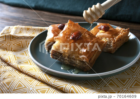 Baklava turkish home made sweets. Baked. A traditional dessert with sugar syrup and walnuts. Baklava turkish home made sweets. Baked. A traditional dessert with sugar syrup and walnuts. 70164609