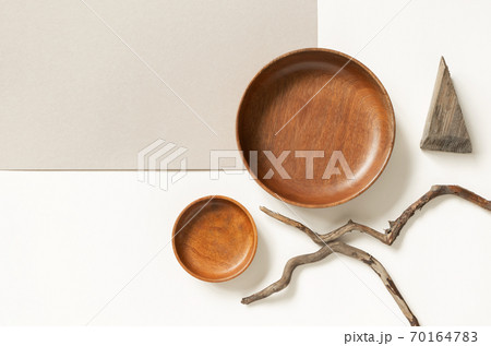 Empty wooden plates and tree branches on two neutral beige colors paper backgrounds, top view. Rustic cafe or restaurant menu concept. Flat lay composition 70164783