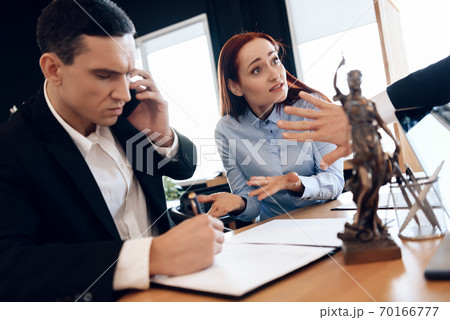 Man in a suit speaks on phone and puts signature. Man in a suit speaks on phone and puts signature. 70166777