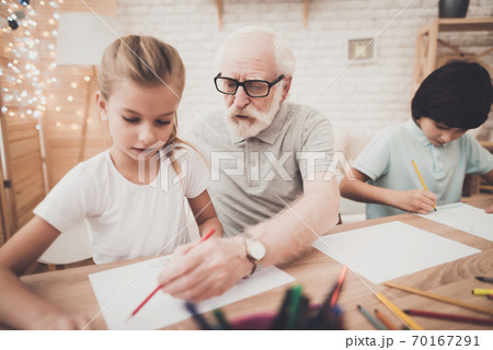 Grandfather, grandson and granddaughter at home. Grandfather, grandson and granddaughter at home. 70167291