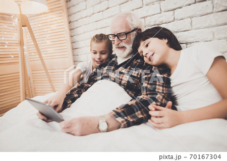 Grandpa and children are using tablet. Grandpa and children are using tablet. 70167304