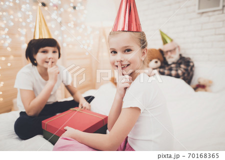 Children opening present while grandpa is sleeping Children opening present while grandpa is sleeping 70168365