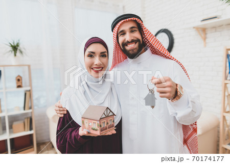 Arab family holds keys to new apartment and smiles Arab family holds keys to new apartment and smiles 70174177