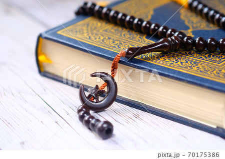 Holy book Quran and rosary on table, close up. Holy book Quran and rosary on table, close up. 70175386