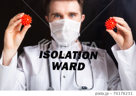 Covid-19 ward, Vaccine development and medicine concept - Doctor in flu mask holding a model of coronavirus. Covid-19 ward, Vaccine development and medicine concept - Doctor in flu mask holding a model of coronavirus. 70176231