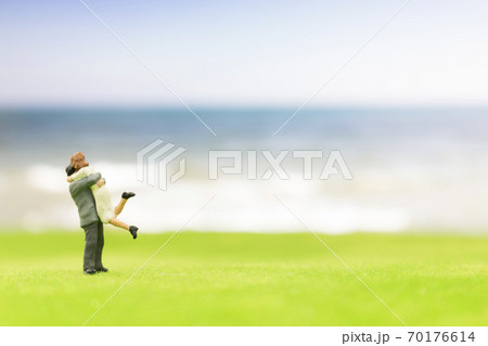 Miniature couple on the beach Miniature couple on the beach 70176614