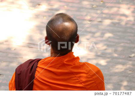 Head and beside of Asian monks or buddhist monks which wears a dress in yellow. 70177487