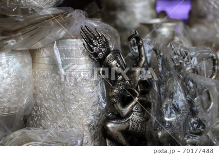 Silver souvenir dancer doll in traditional dress of Cambodia among many silver. Silver souvenir dancer doll in traditional dress of Cambodia among many silver. 70177488