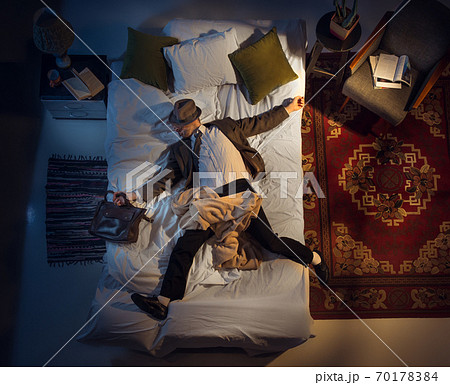 Portrait of a businessman, accountant sleeping in the bed at home Portrait of a businessman, accountant sleeping in the bed at home 70178384