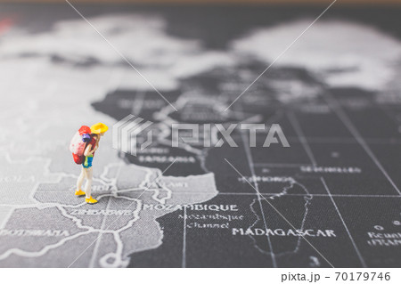 Miniature people backpacker walking on world map Miniature people backpacker walking on world map 70179746