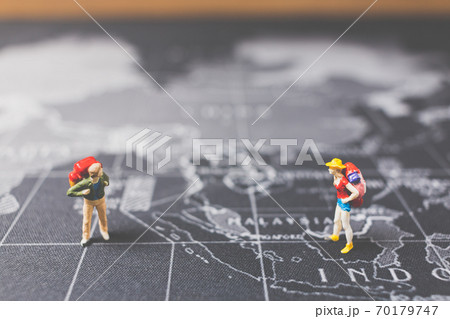 Miniature people backpacker walking on world map 70179747