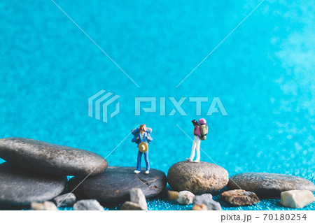 Miniature Backpacker , Tourist people on blue glitter background Miniature Backpacker , Tourist people on blue glitter background 70180254