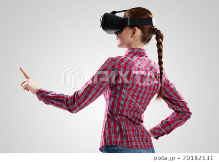 Girl in mask experiencing virtual reality as new entertainment device Girl in mask experiencing virtual reality as new entertainment device 70182131