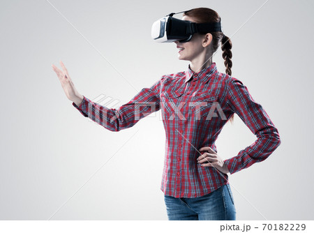 Girl in mask experiencing virtual reality as new entertainment device Girl in mask experiencing virtual reality as new entertainment device 70182229