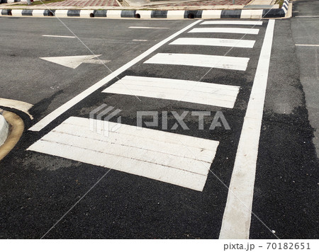 Zebra crossing for pedestrians on the road. Made of thermoplastic material and has light-reflective particles. Provides safety advantages to pedestrians. 70182651