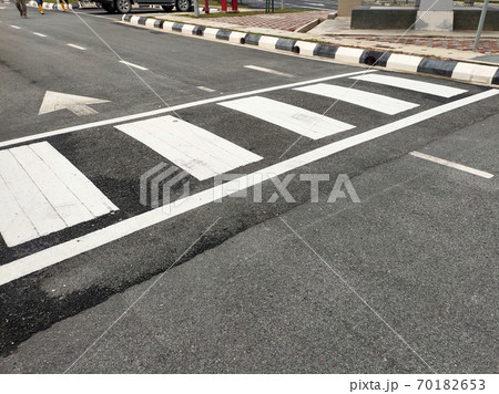 Zebra crossing for pedestrians on the road. Made of thermoplastic material and has light-reflective particles. Provides safety advantages to pedestrians. Zebra crossing for pedestrians on the road. Made of thermoplastic material and has light-reflective particles. Provides safety advantages to pedestrians. 70182653