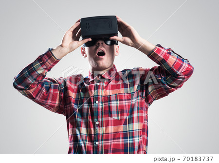 Guy in mask experiencing virtual reality as new entertainment device 70183737