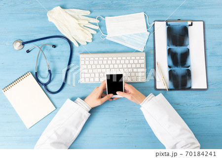 Top view of doctor hand holding smartphone Top view of doctor hand holding smartphone 70184241