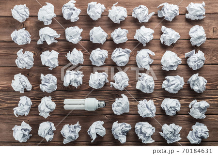 Ideological concept with wastepaper light bulb on wooden table 70184631