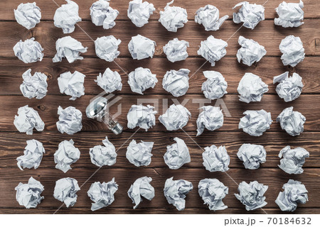 Ideological concept with wastepaper light bulb on wooden table 70184632